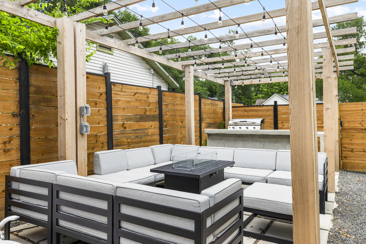 Relax and unwind under twinkling lights in this chic backyard retreat!