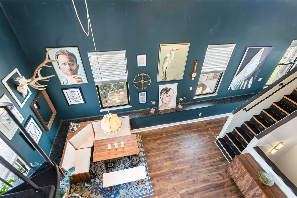 Look up! Art climbs the walls beneath soaring ceilings in one of the home&rsquo;s most unforgettable spaces.