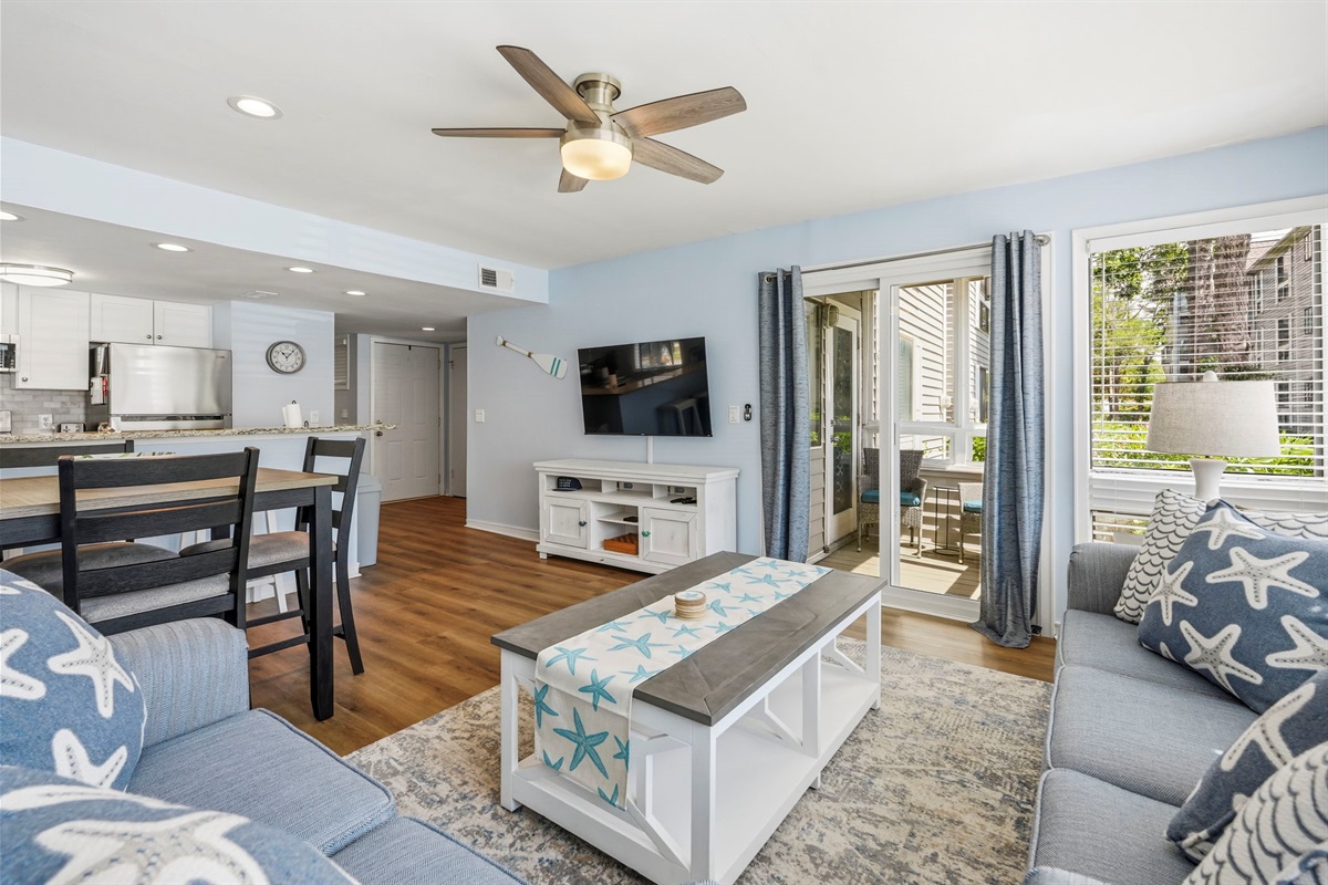 Beautiful living room connected to kitchen with views of Arcadian Shores