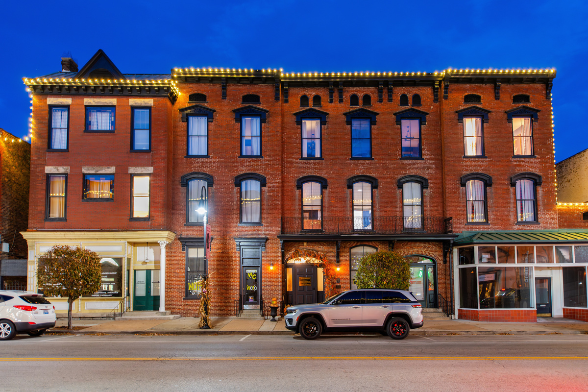 The Woodford Hotel at night, with lights outlining the roof.