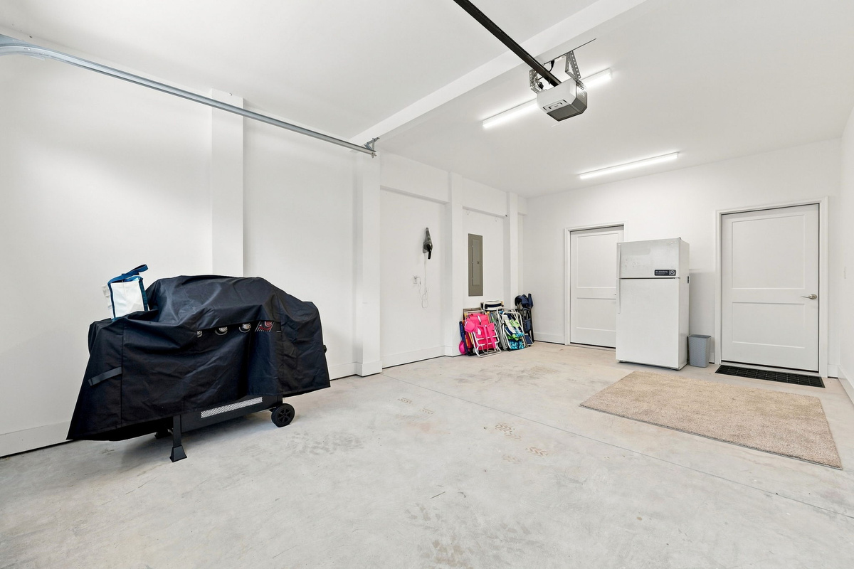 Large garage area offering plenty of room for parking, storage, and vacation essentials