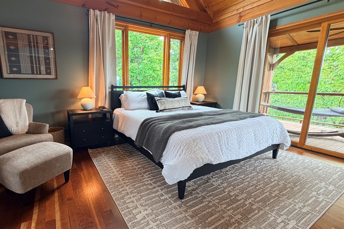 Cozy king bedroom with blackout curtains.