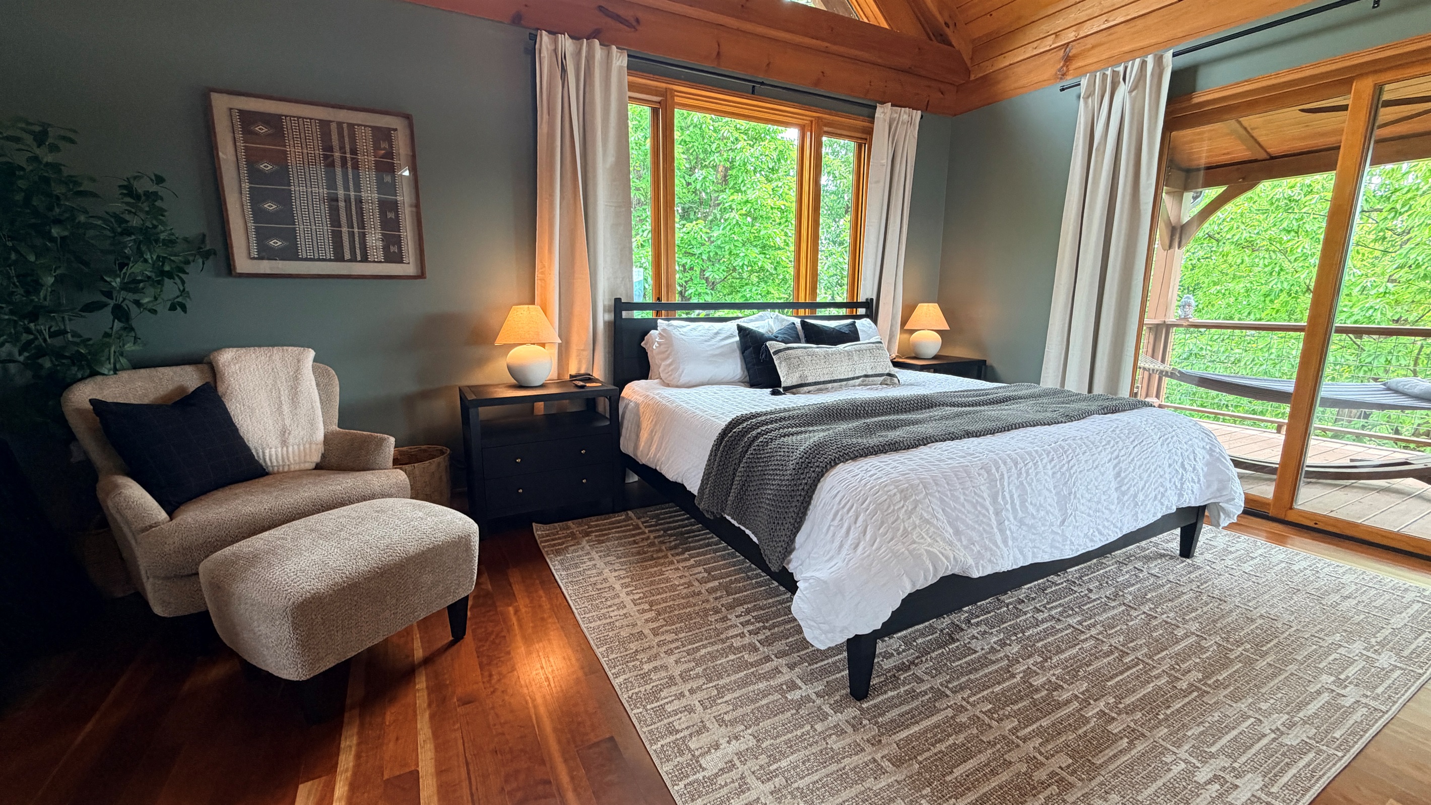 Cozy king bedroom with blackout curtains.