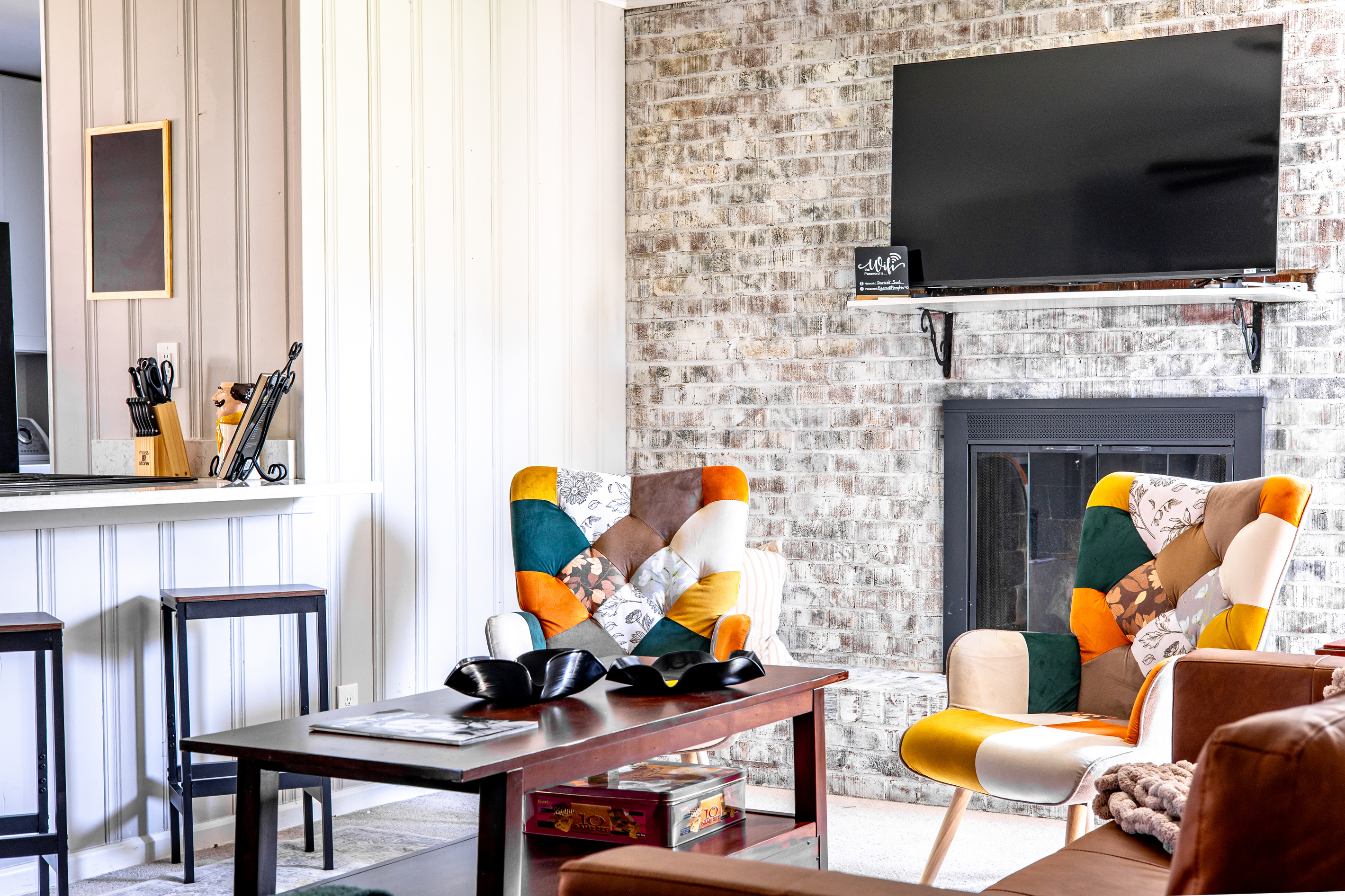 Living room that opens to the kitchen. Plenty of seating, decorative fireplace, TV