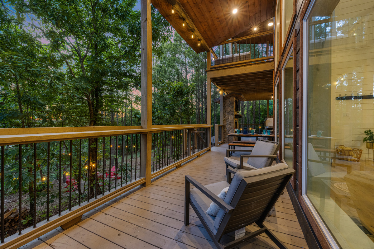 A relaxed outdoor seating spot just outside the cabin, featuring comfortable chairs where you can sit back, take in the surroundings, and enjoy the calm, open-air atmosphere.