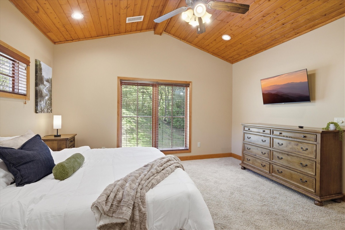Drift off in the king bedroom in Unit 321, with a comfortable setup and a quiet, cabin-style feel that makes it easy to settle in for the night.