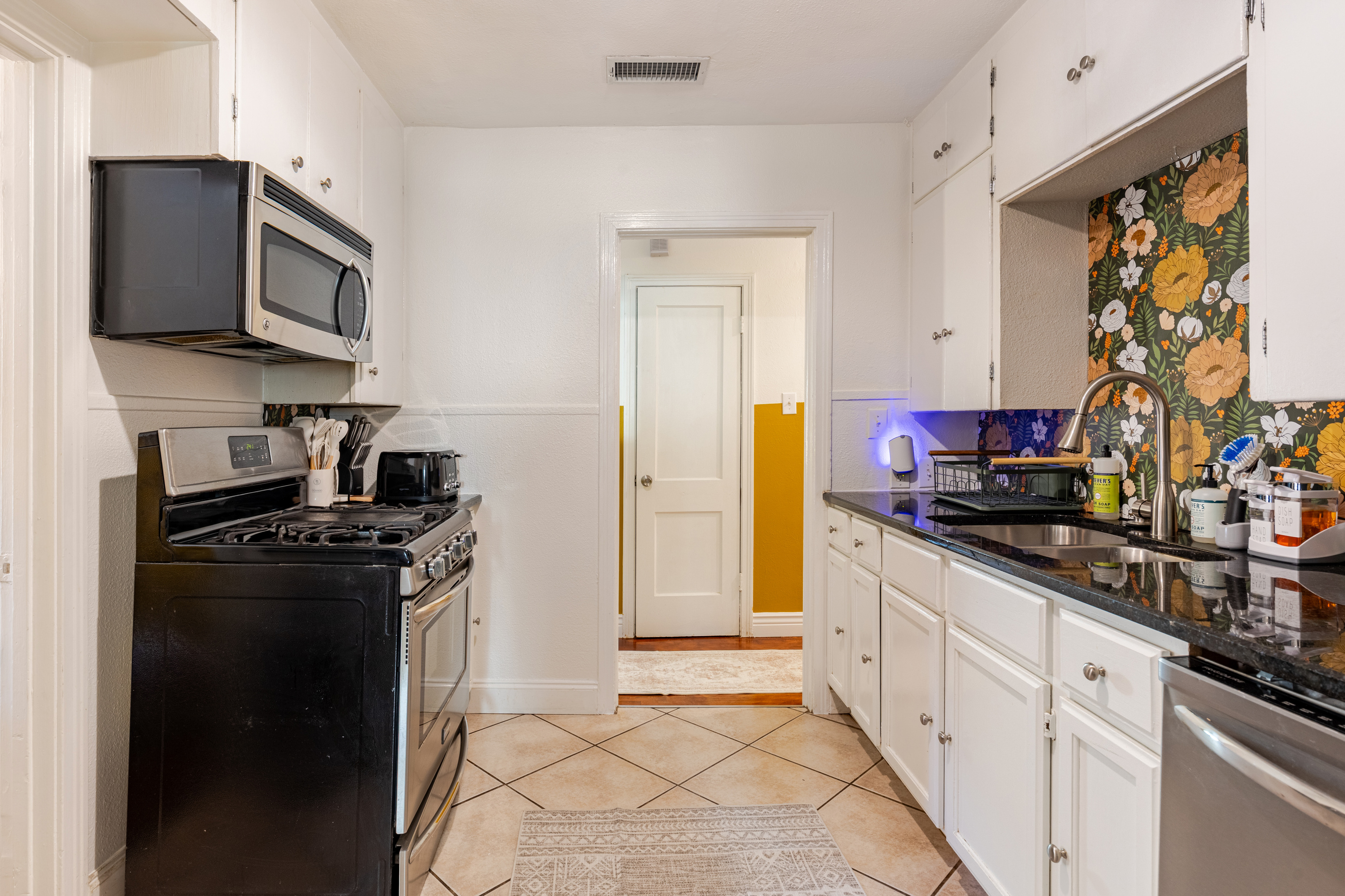 Bright floral accents and modern appliances await your culinary adventures!