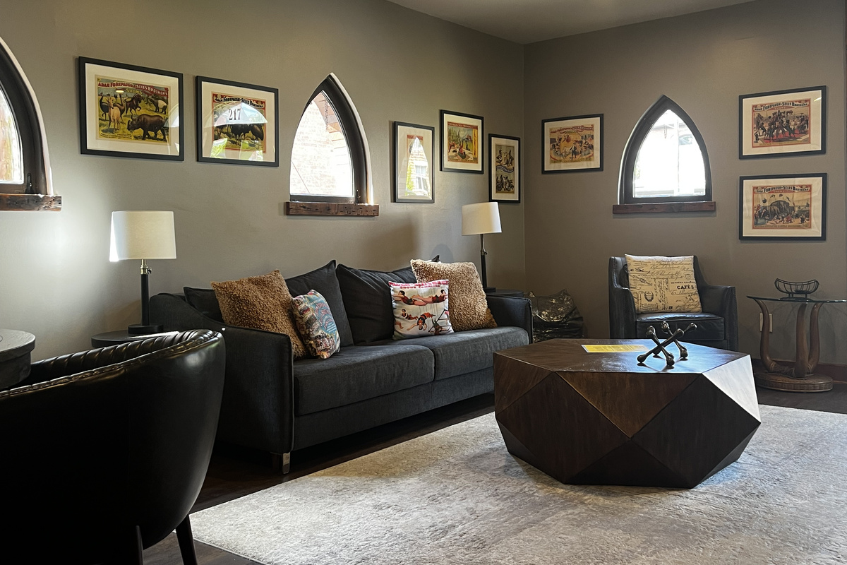 Living area with the King sleeper sofa, vintage circus posters and Gothic windows