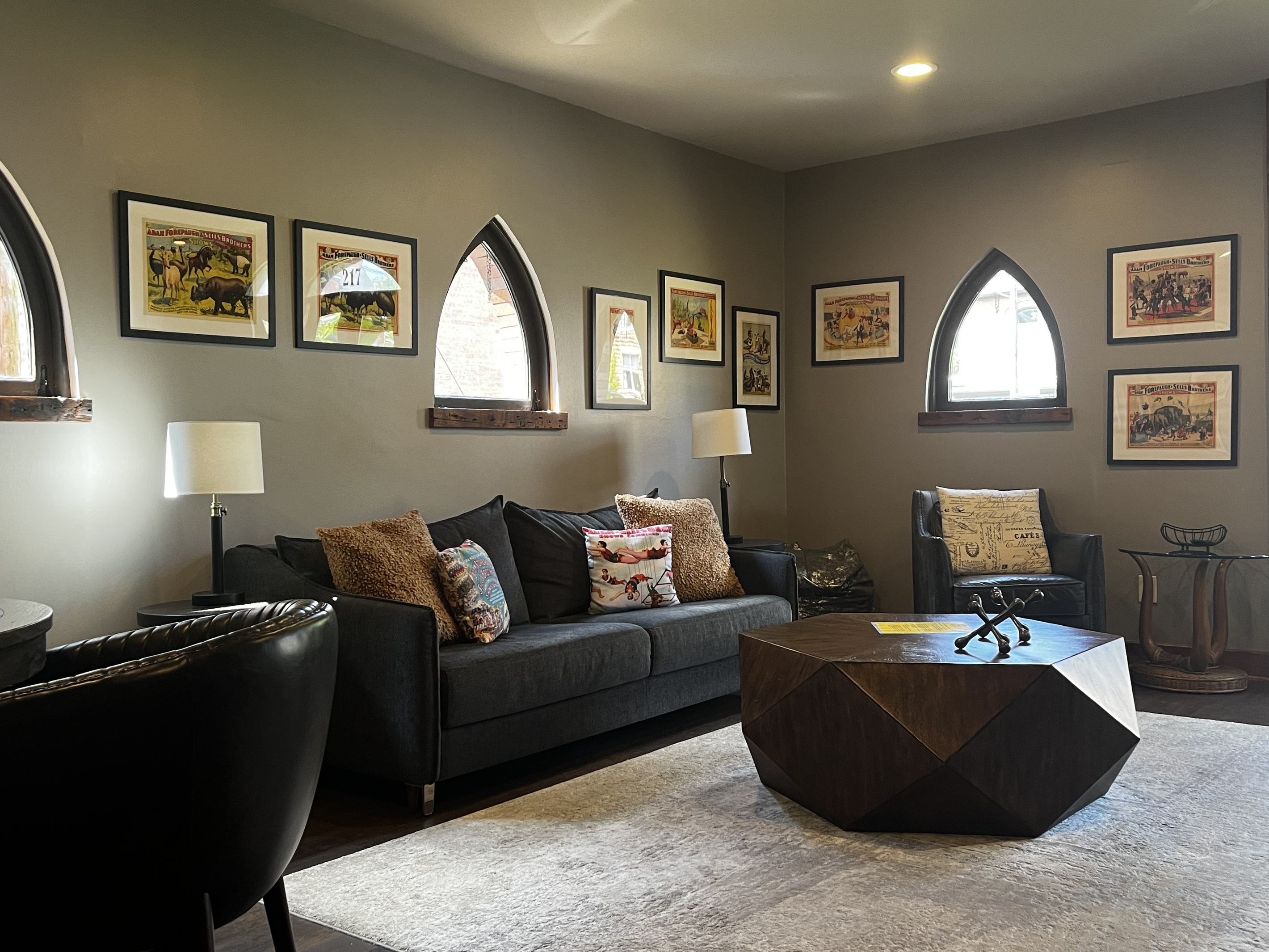 Living area with the King sleeper sofa, vintage circus posters and Gothic windows
