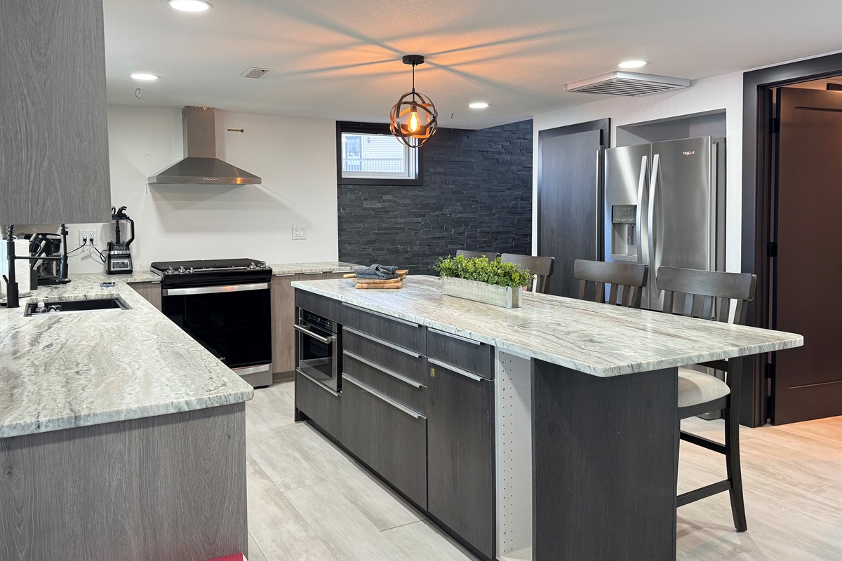 Large Kitchen with microwave, gas stove, and large refrigerator