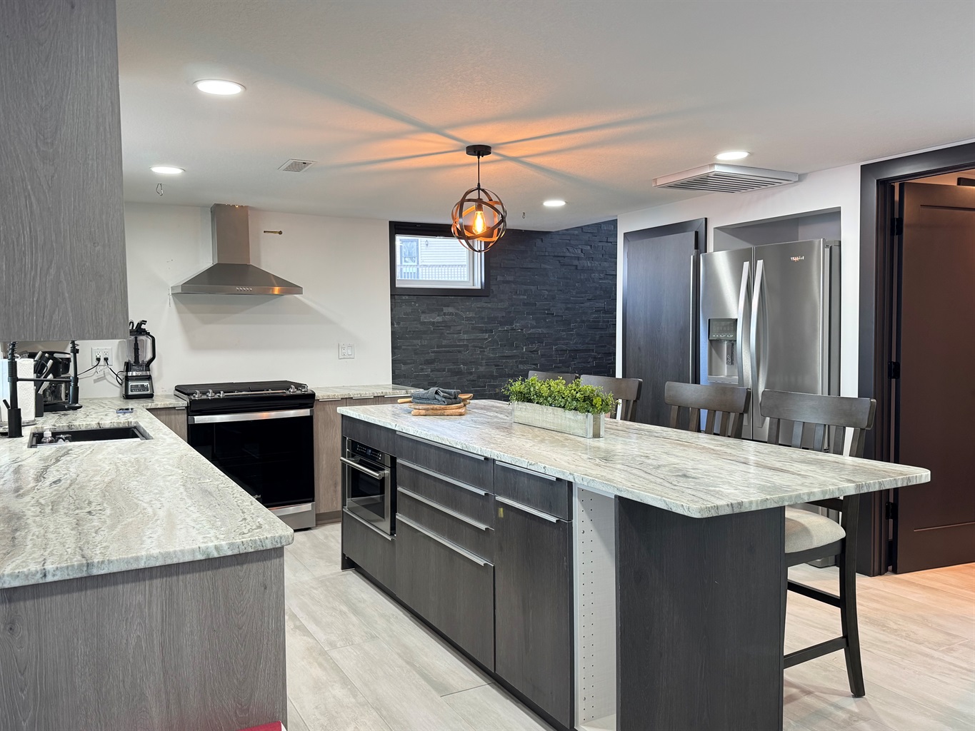 Large Kitchen with microwave, gas stove, and large refrigerator