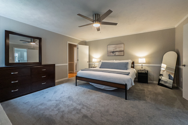King bed, 55" Smart TV, ceiling fan, two led light nightstands with multiple charging ports, two multi light function lamps, blackout curtains, dresser, wardrobe closet, full length mirror, stylish brick fireplace - not in use.