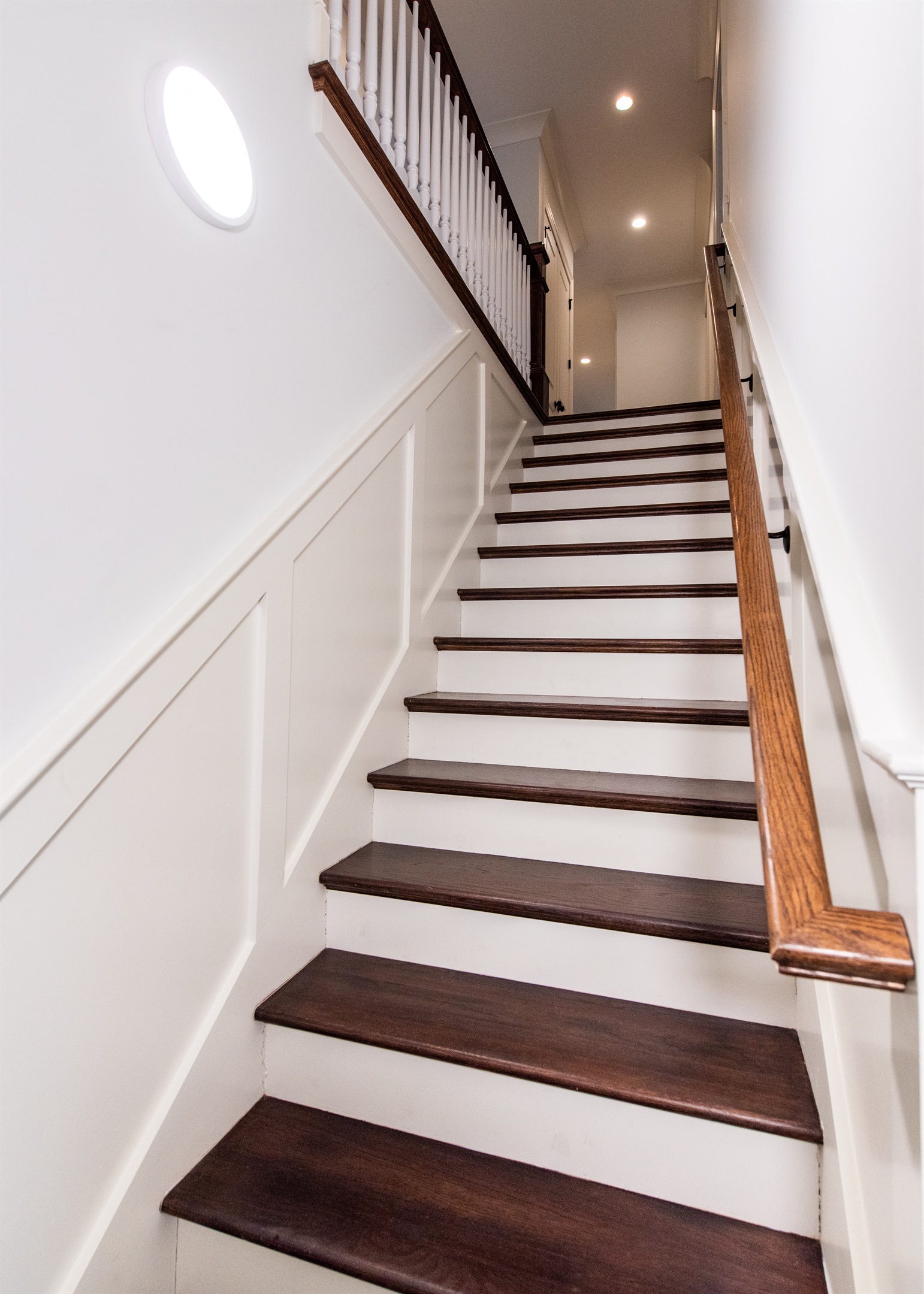 Staircase leading to cozy bedrooms, offering a warm and inviting ascent.