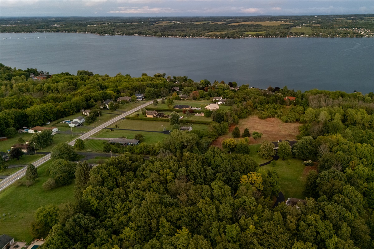 Stunning aerial view showcasing the serene beauty of the lake, lush greenery, and peaceful surrounding neighborhood. Perfect for highlighting location and natural setting.