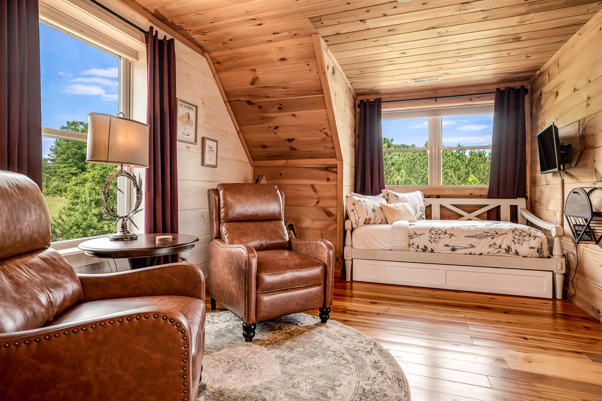 Additional view of the loft area with a twin bed featuring a trundle
