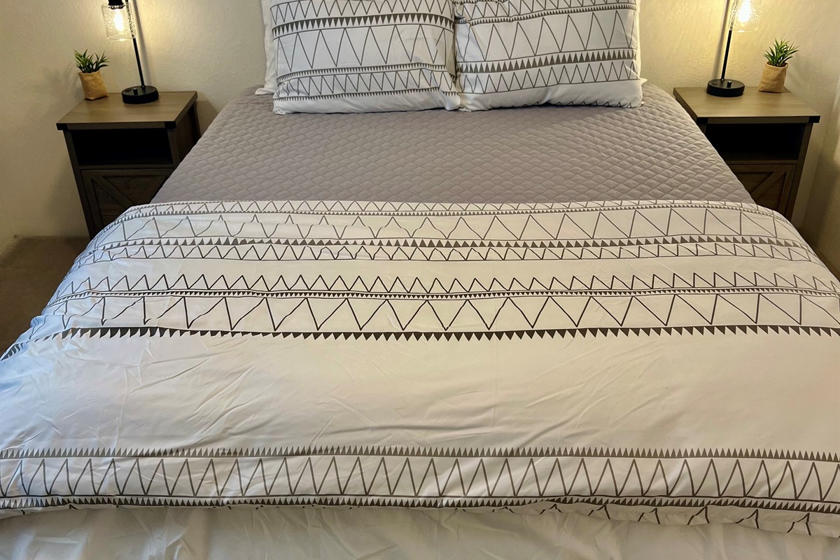 Unwind in the cozy third bedroom, complete with a plush queen-size bed and soft linens.