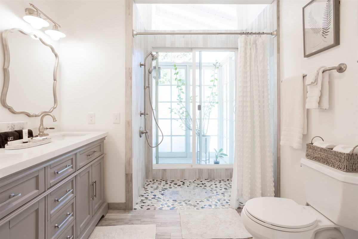Extra large walk-in shower with double sink.