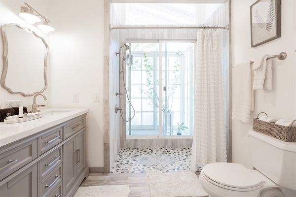 Extra large walk-in shower with double sink.