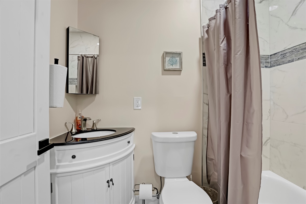 The bathroom offers all the essentials in a cozy, practical space.
