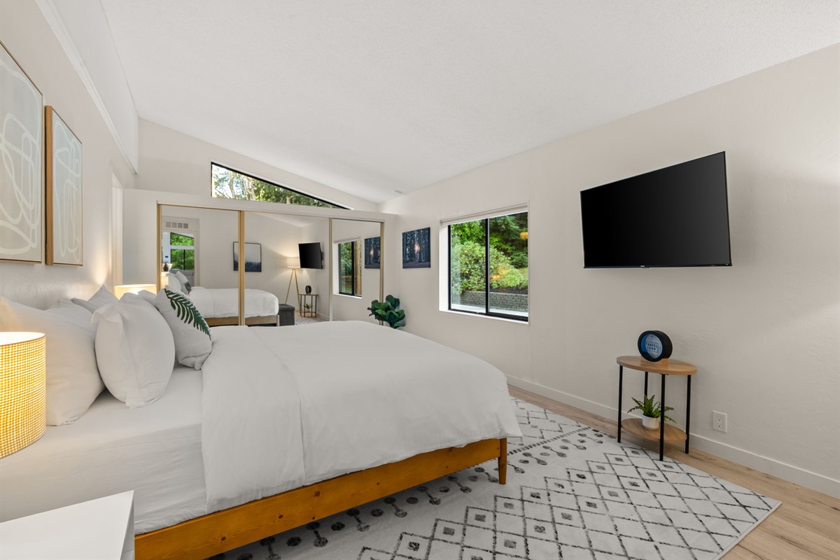 Spacious and serene—this primary bedroom offers a calming retreat with nature right outside your window