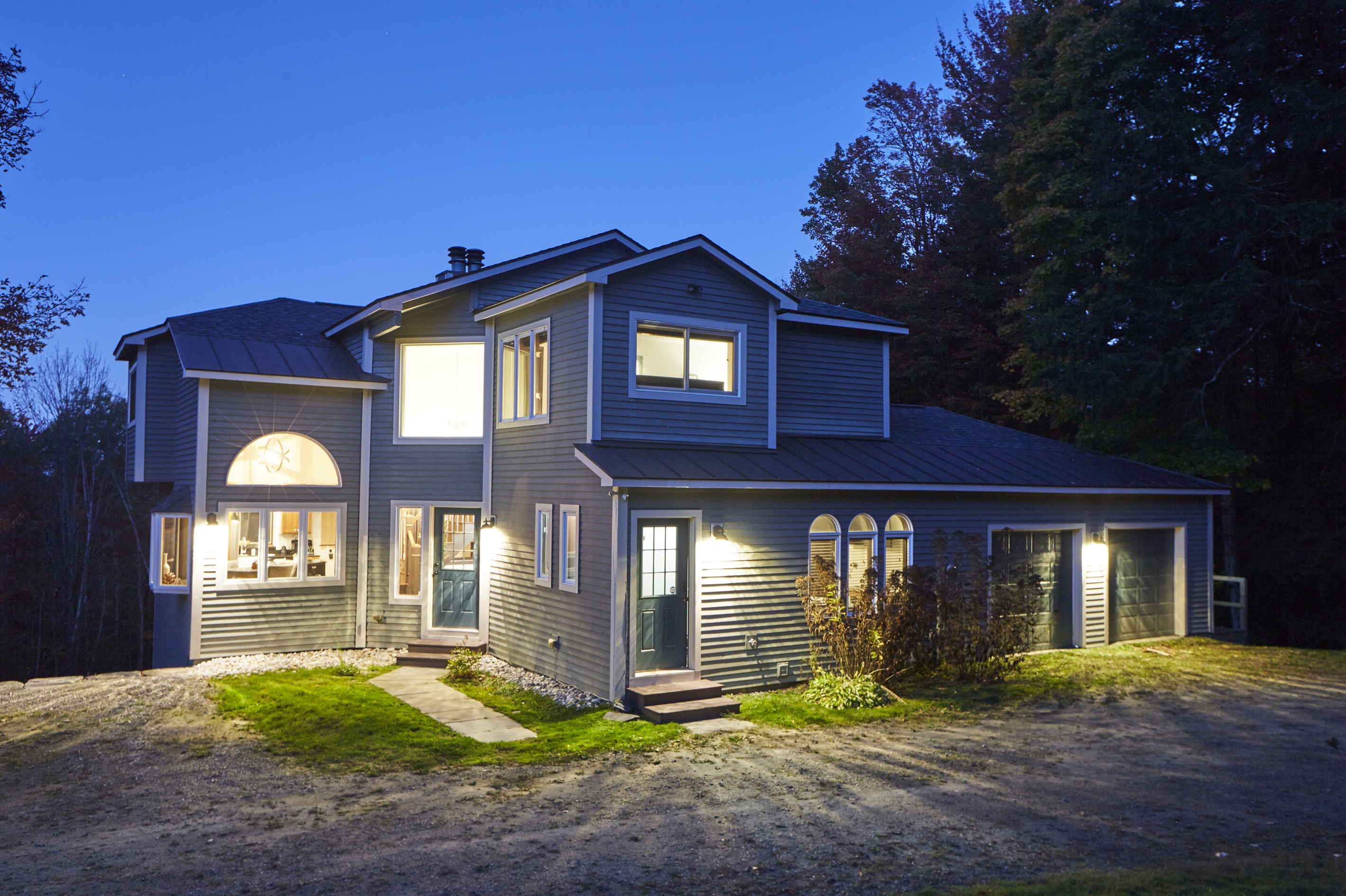 As the sun sets, the home radiates warmth and charm, creating a picturesque setting for your mountain getaway.