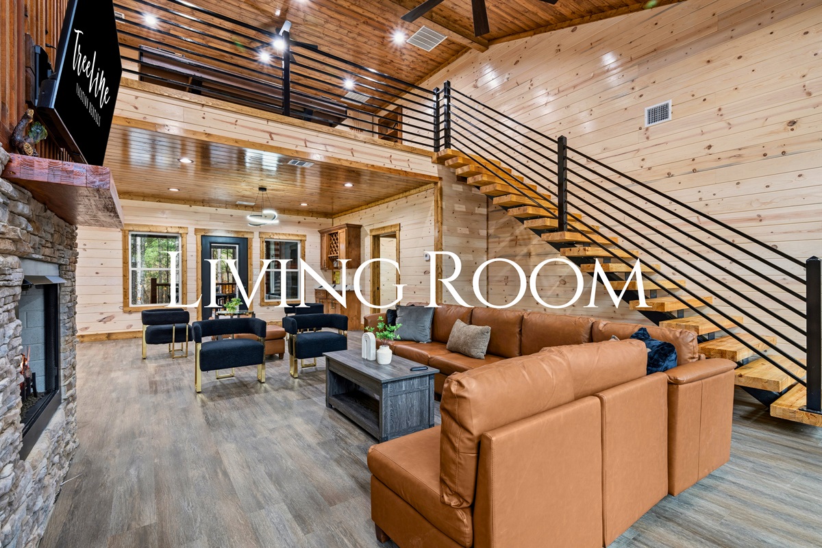 The open living room greets you with soaring ceilings, warm wood finishes, and comfortable seating that makes it easy for everyone to settle in after a day of exploring.