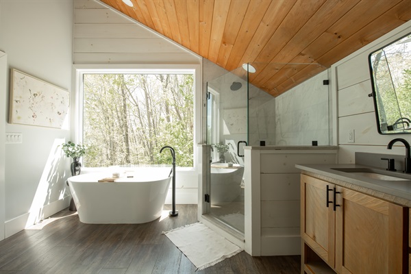 King Suite 1 Bath | Soaking tub with serene forest views 