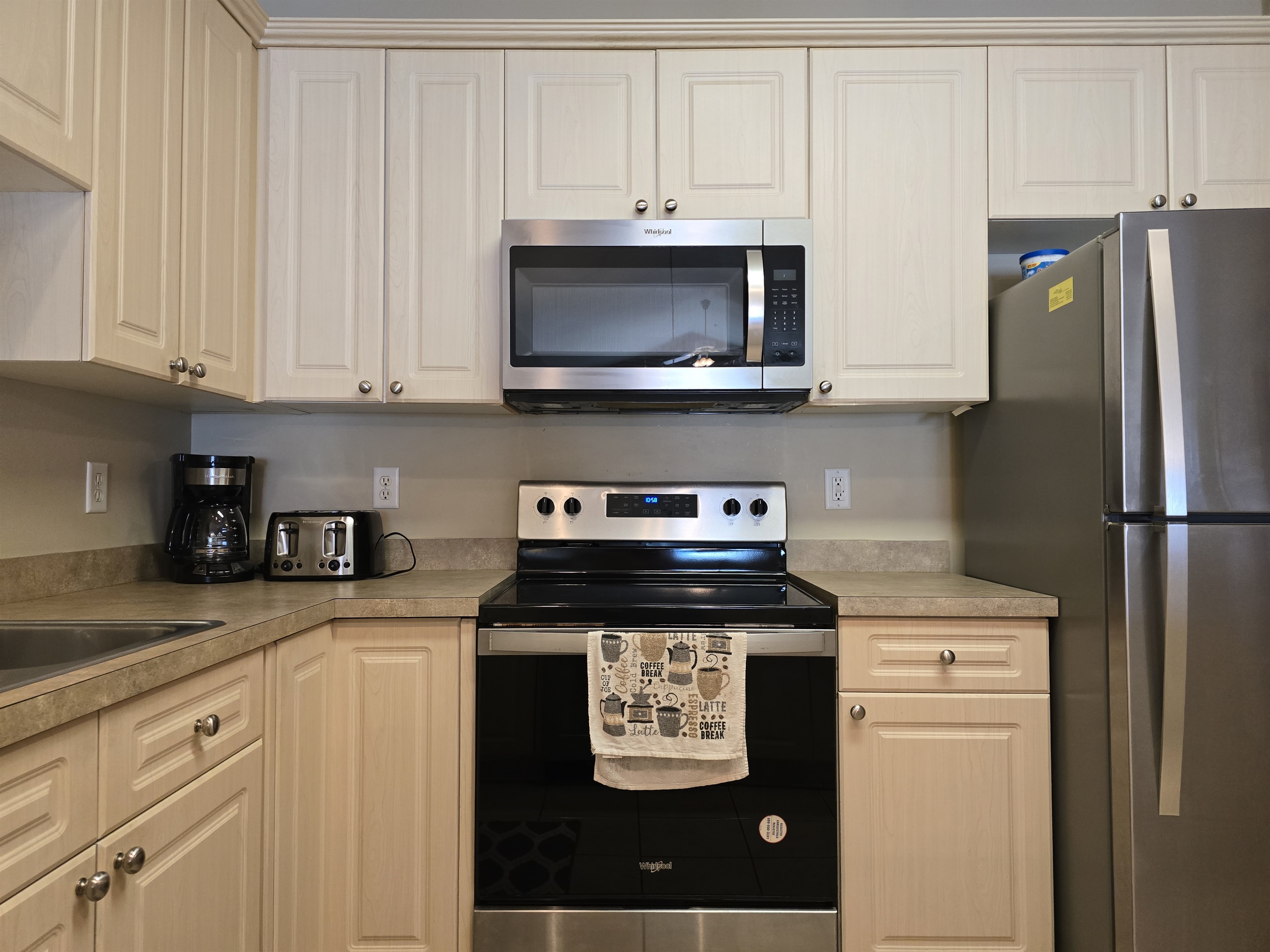 Full Kitchen with Dishwasher, Freezer/Refrigerator, Stove, Microwave, Breakfast Bar.