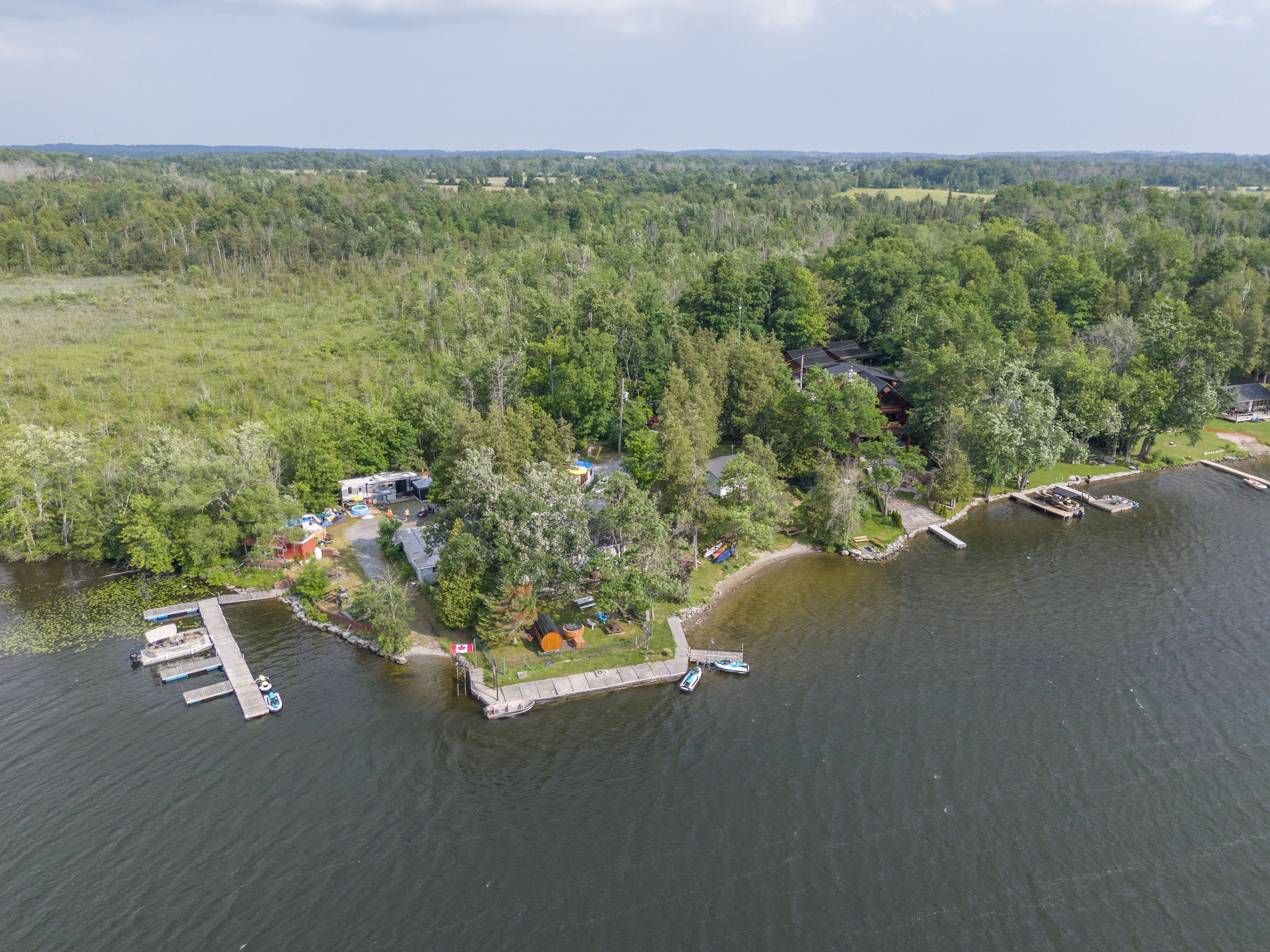 Elevated view of the waterfront property and surrounding landscape