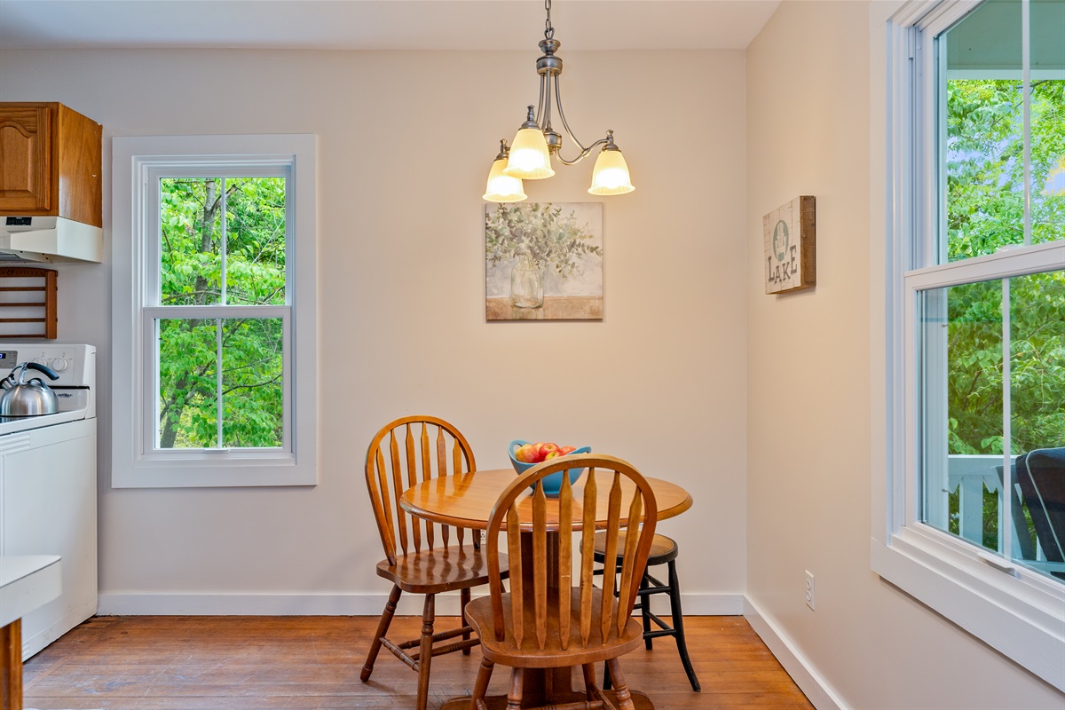 Share meals and memories at a warm wooden dining table, framed by natural light and cheerful décor.