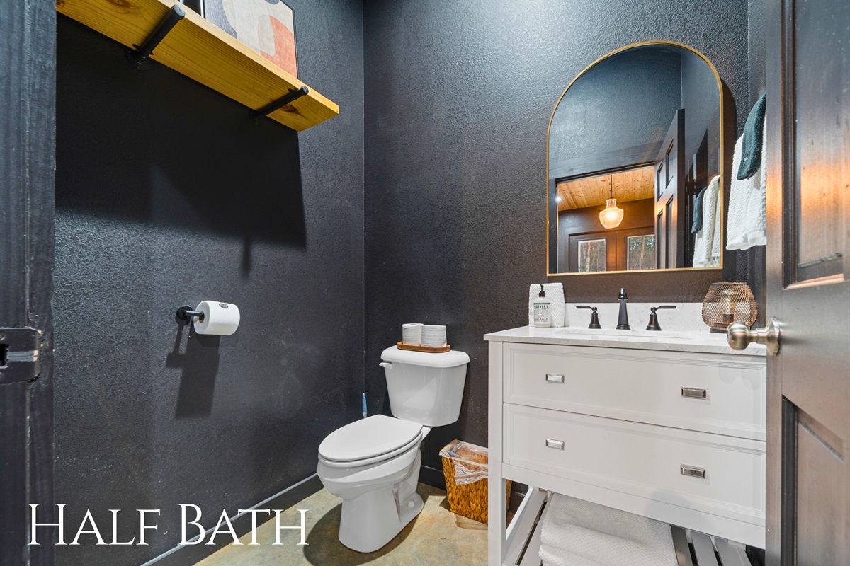 This half bath is conveniently located and finished with clean lines and modern touches that feel fresh and welcoming.