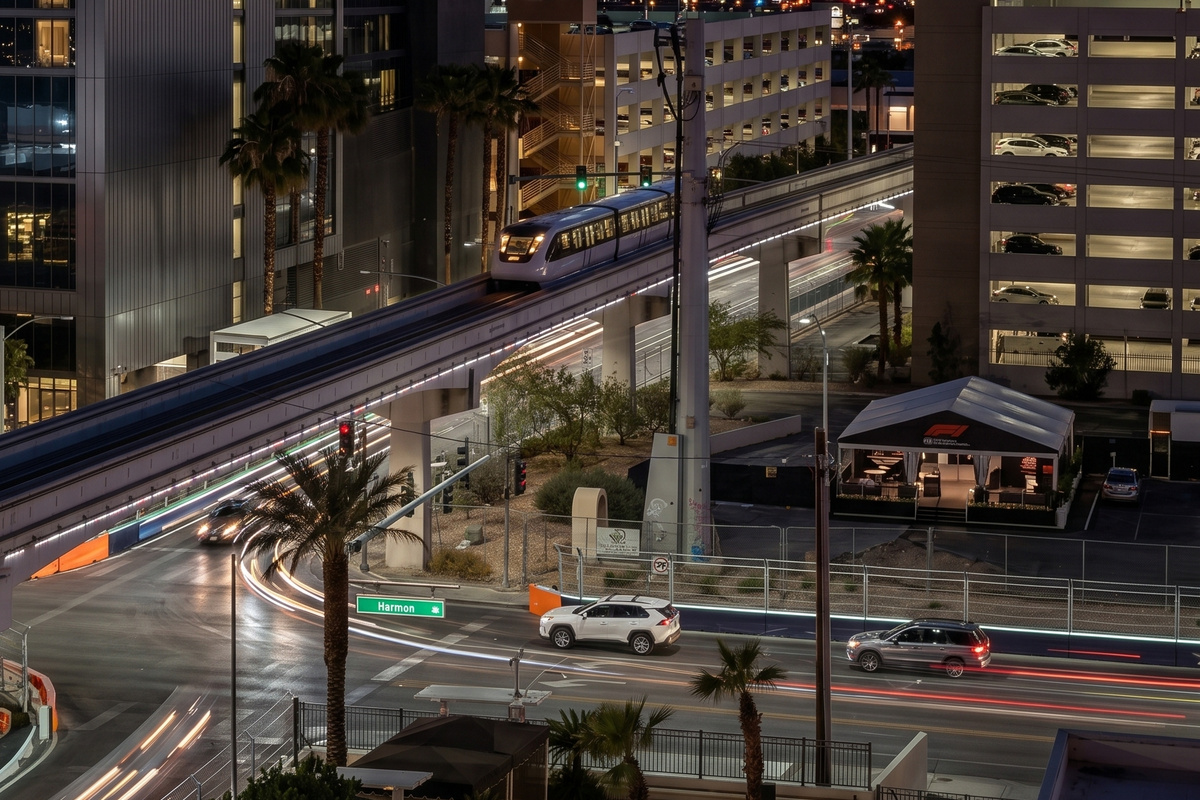 Harmon Avenue at night, the F1 corridor lit below the window. MGM Signature puts you on the race line and a short walk from the Strip.