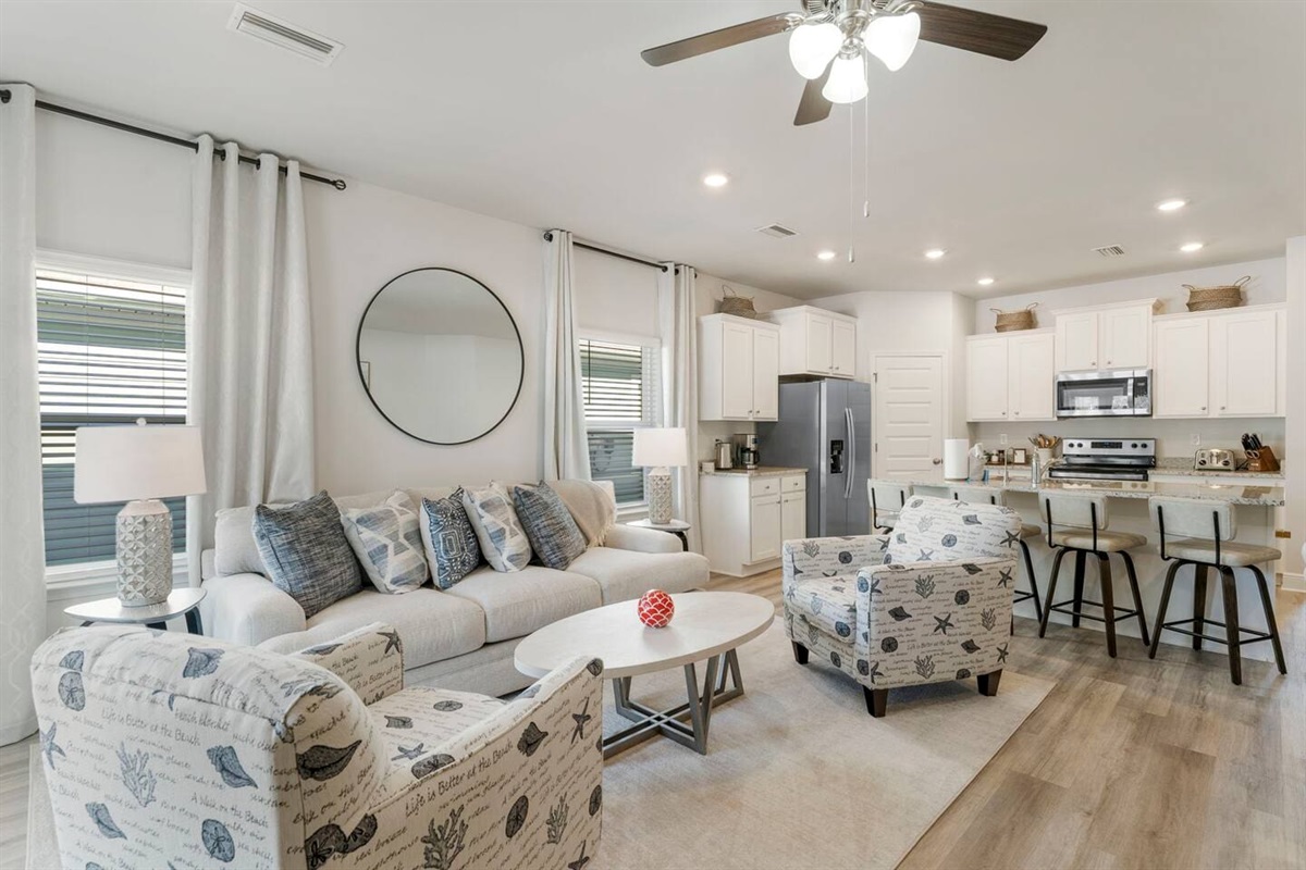 An open living space designed for connection, flowing seamlessly into the dining area.