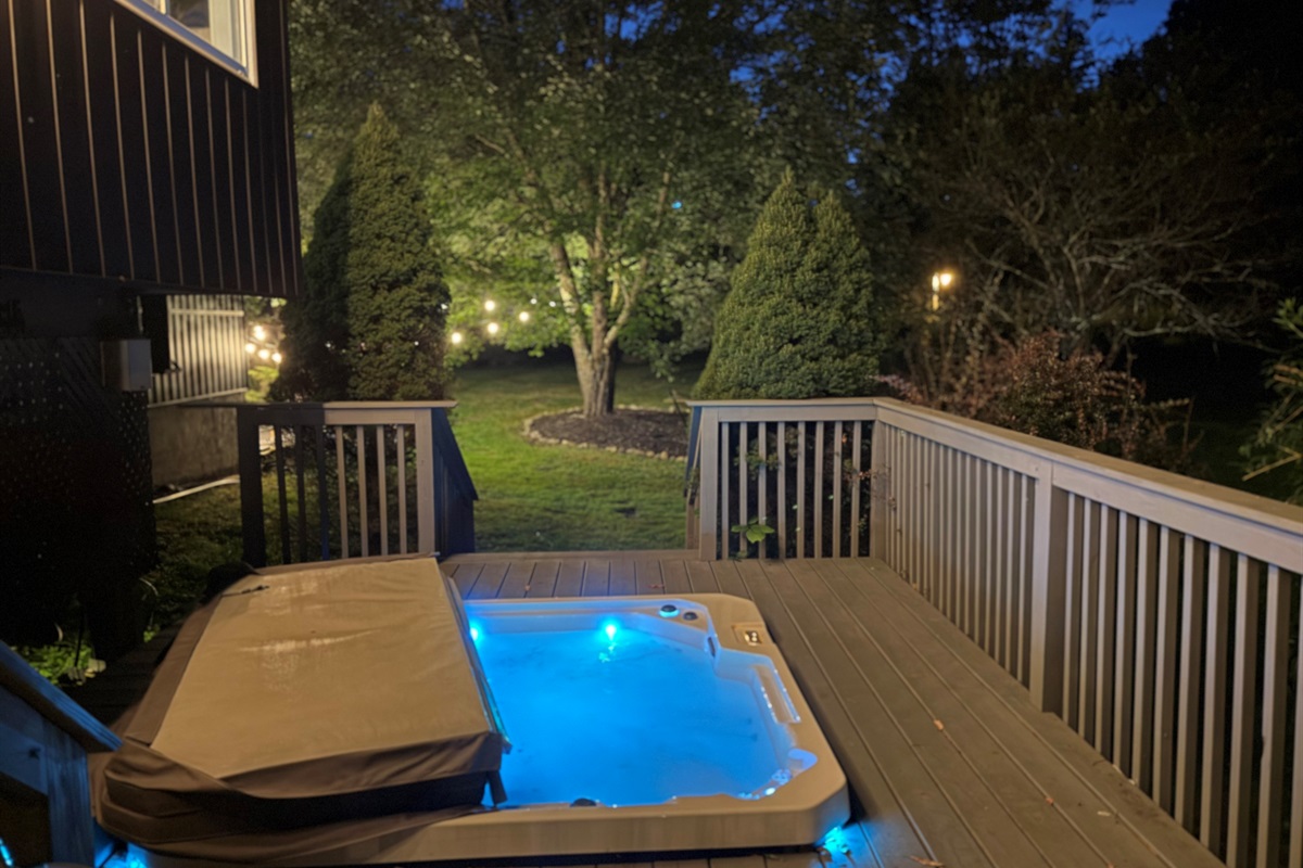 Hot tub in the evening overlooking the backyard