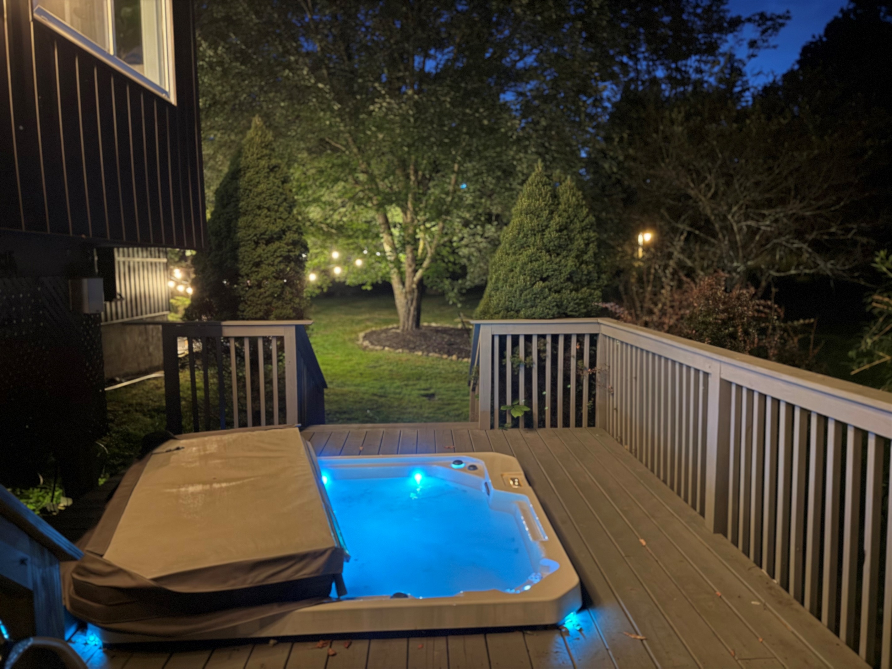 Hot tub in the evening overlooking the backyard