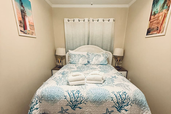 Queen bed with coastal bedding