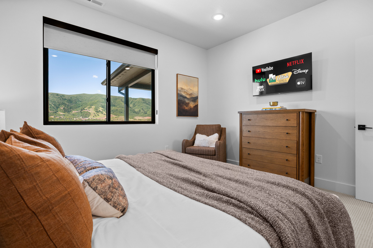 Large bedroom featuring mountain views and a Smart TV.