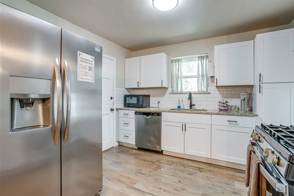 Fully stocked kitchen with stainless steel fridge and everything you need