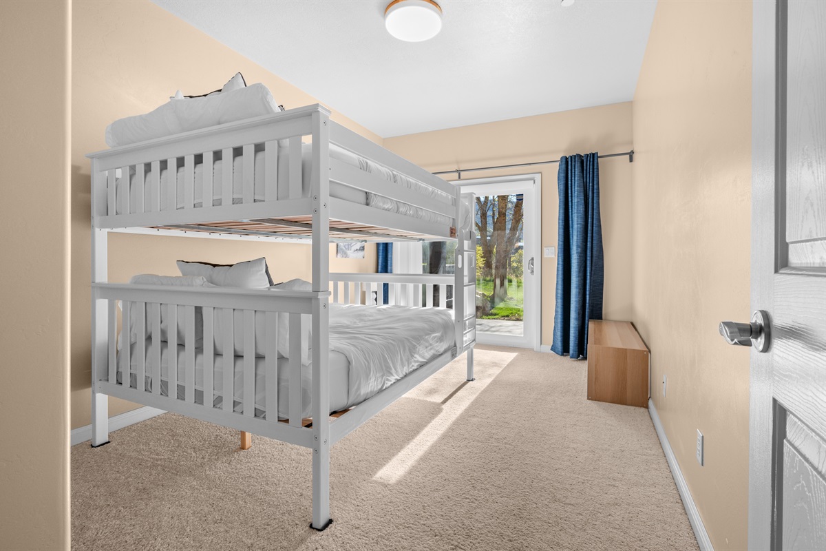 Bright and spacious bunk room offering cozy accommodations for family getaways.