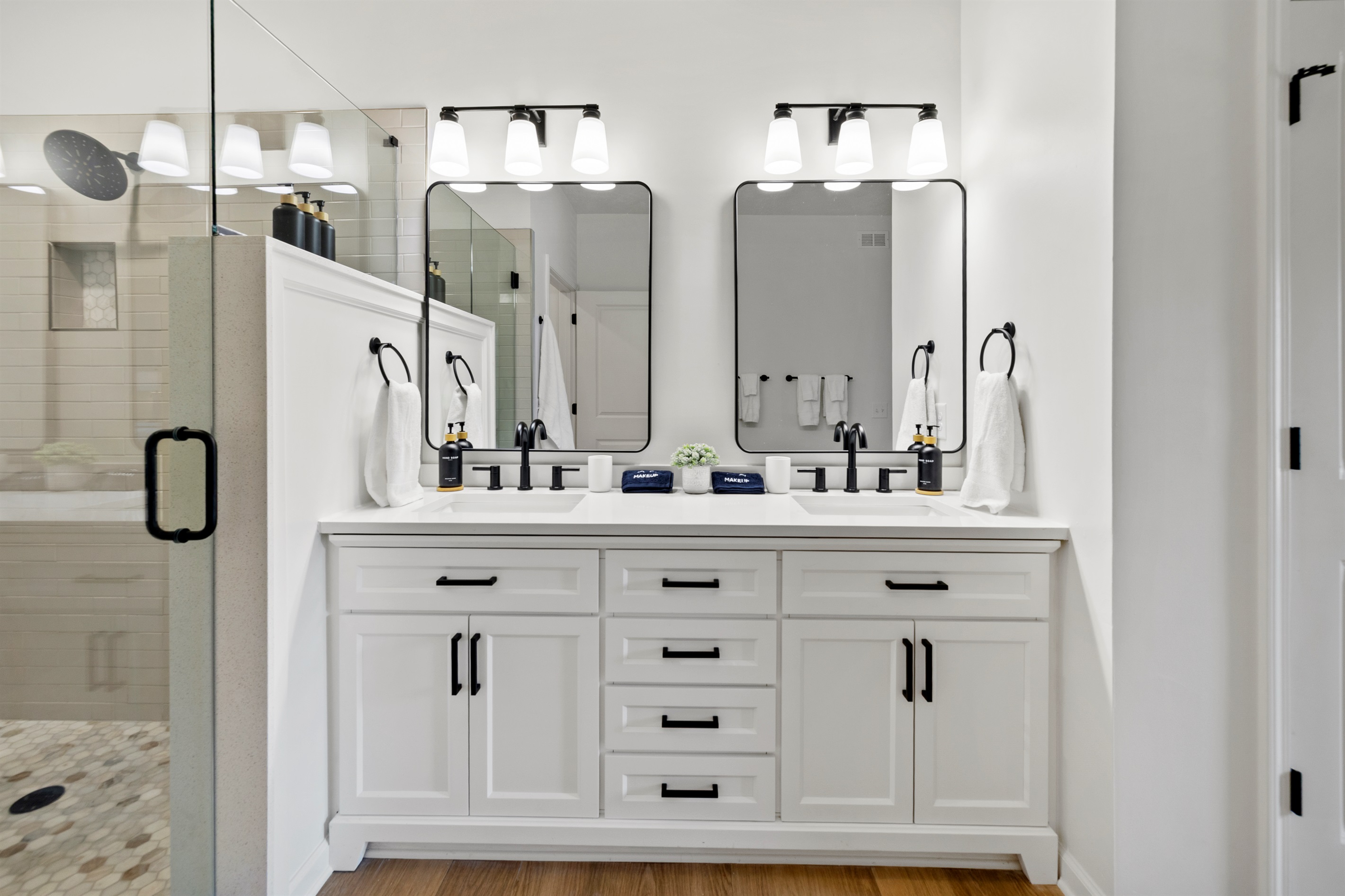 Luxurious master bathroom with oversized shower, private toilet room, roomy walk-in closet, and double sinks.