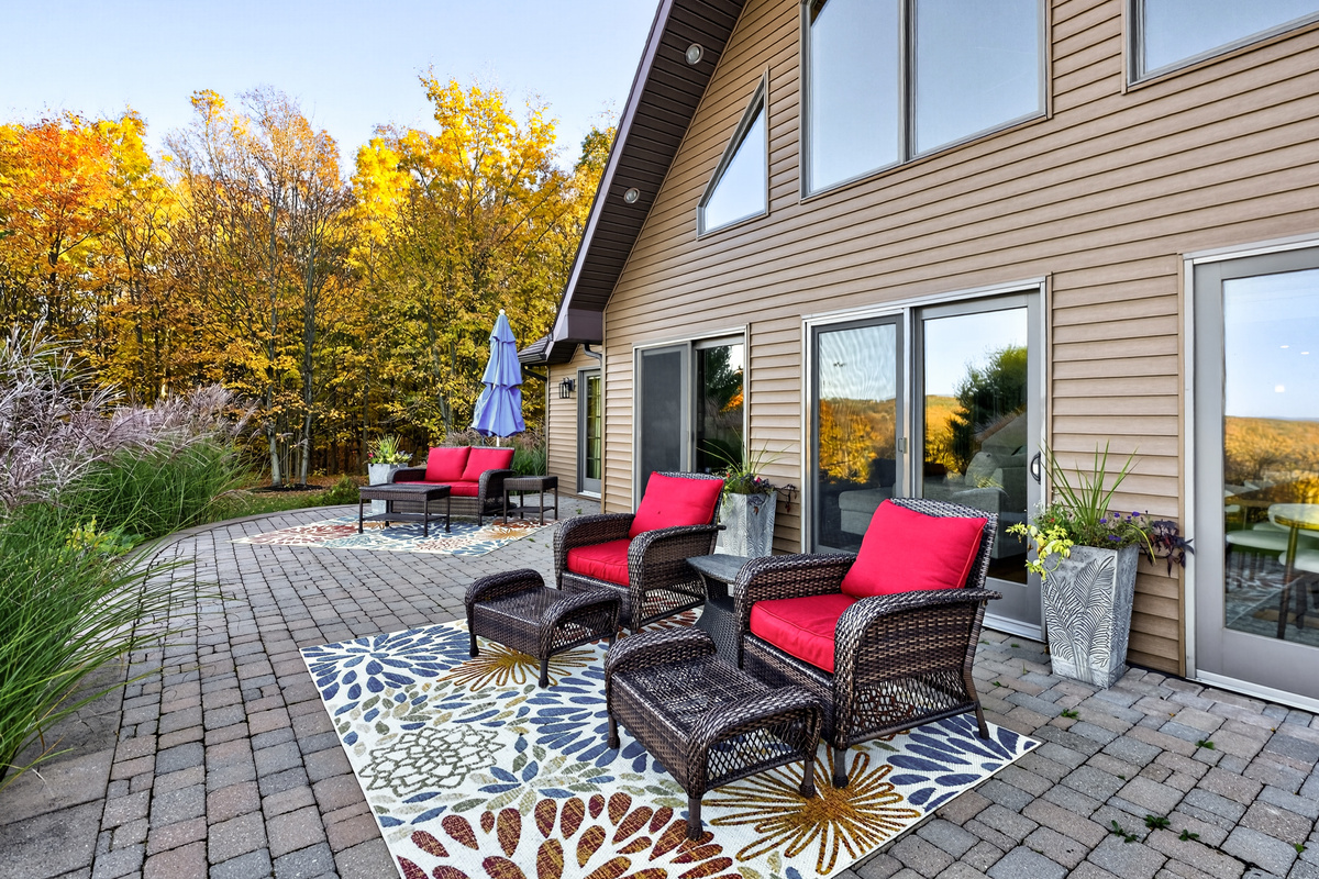 Patio seating with cushioned chairs and outdoor rug