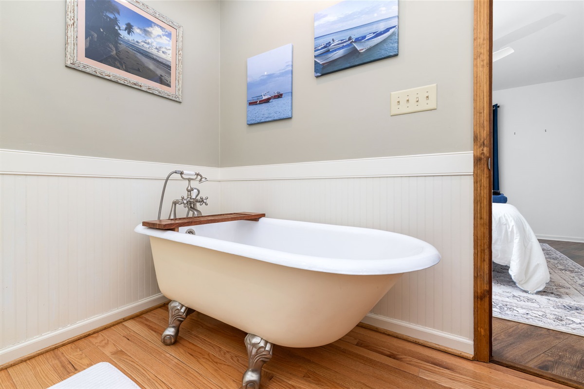 Bathroom Retreat: Unwind in a charming clawfoot tub surrounded by coastal decor!