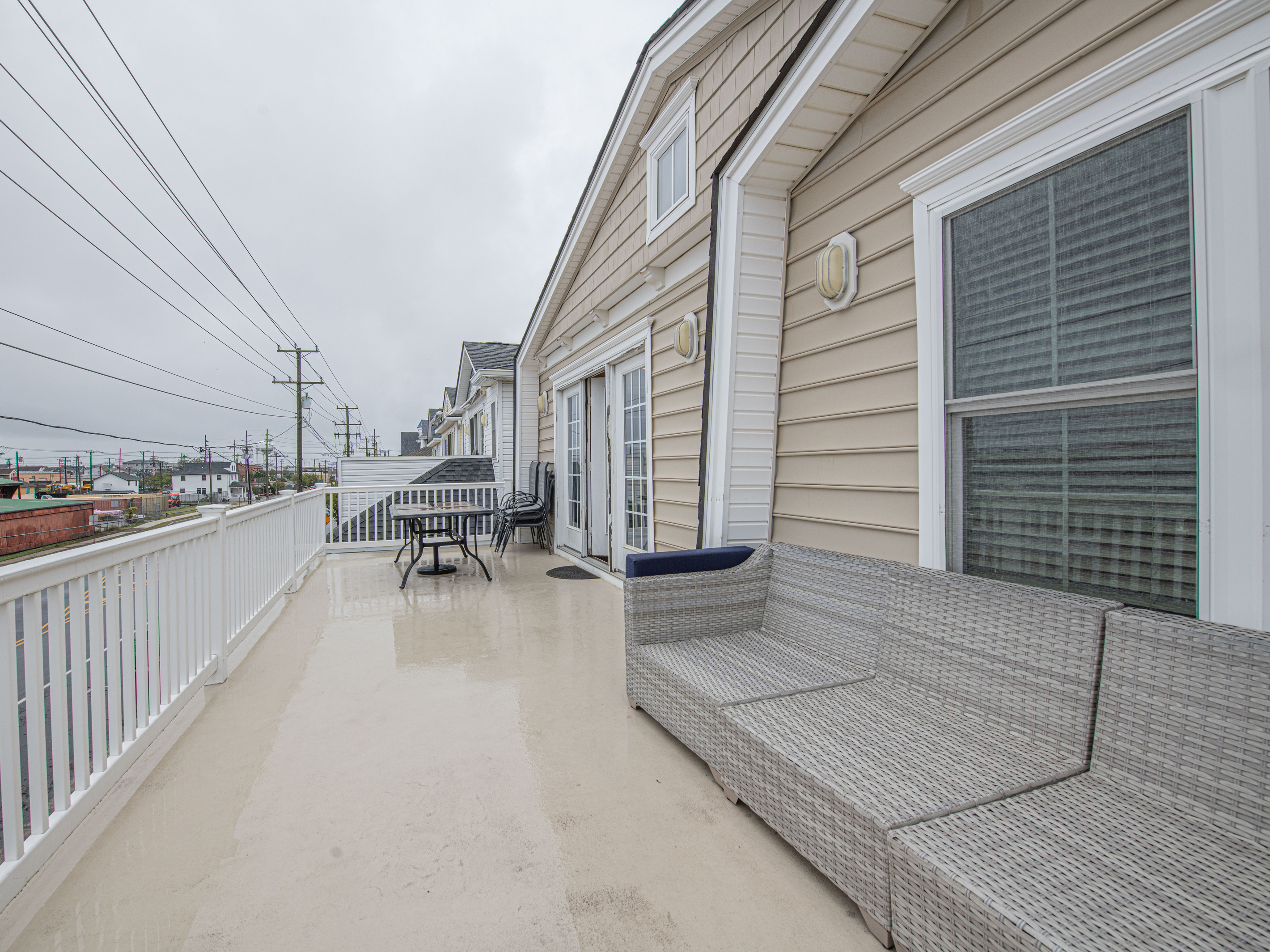 Spacious Upper-Level Balcony Featuring Outdoor Dining Setup