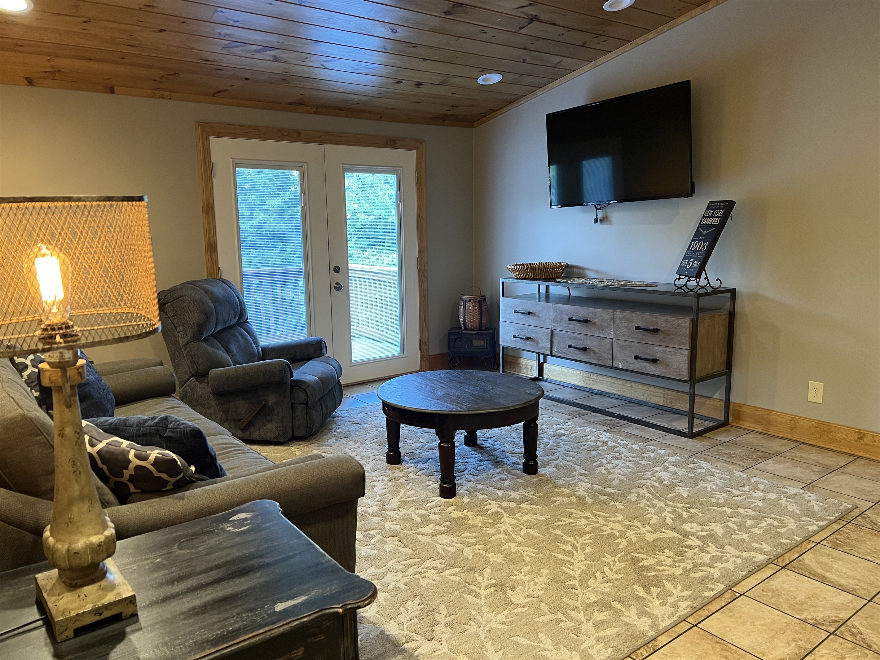 Living room with smart TV and balcony access.