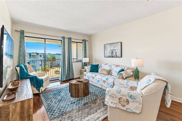 Comfortable living room with 65" smart TV and sleeper sofa.