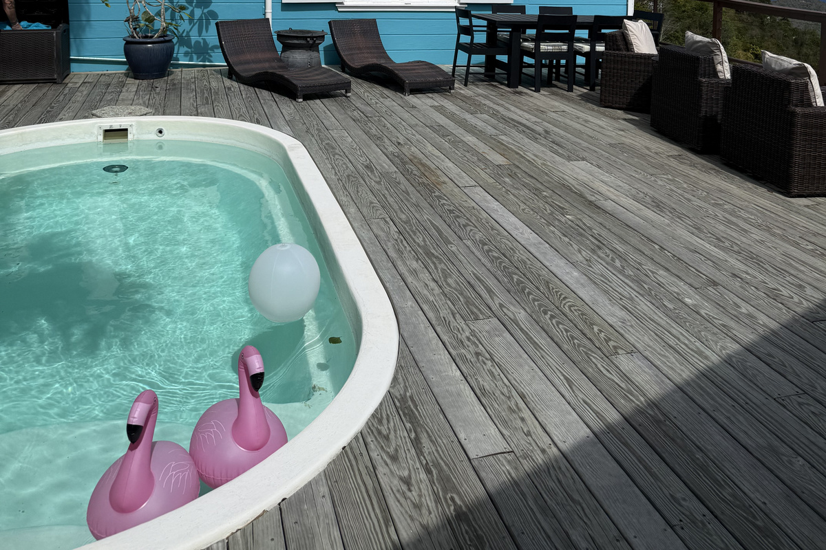 The pool/deck is in between the bedrooms and main living area.