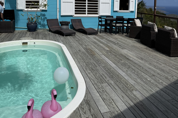The pool/deck is in between the bedrooms and main living area.