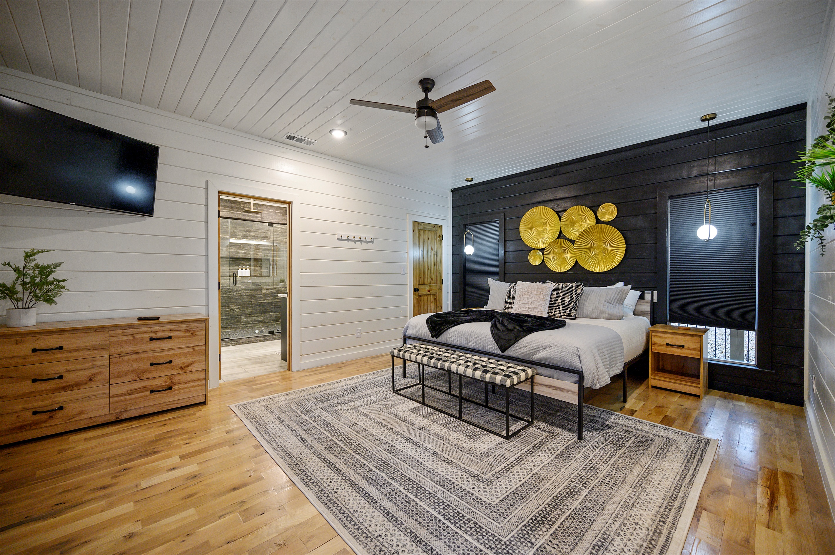 A peaceful king suite designed for comfort and relaxation — featuring a plush king-sized bed, TV, spacious storage drawers, and a private ensuite bathroom for the perfect cozy retreat after a day of adventure. 🛏️