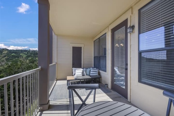 Private balcony with outdoor seating and peaceful views near Lake Travis in Jonestown, TX.