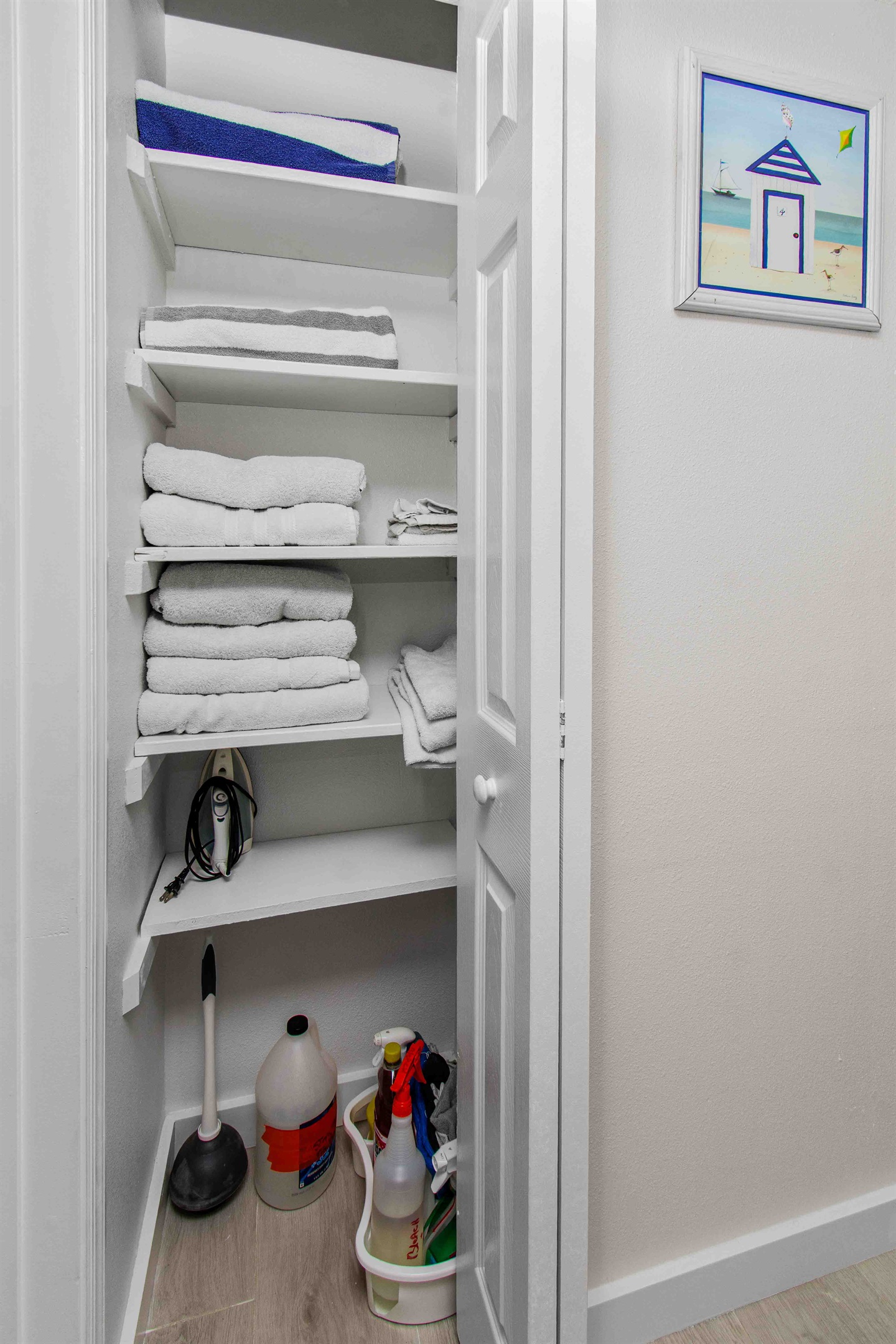 Iron and other supplies in linen closet